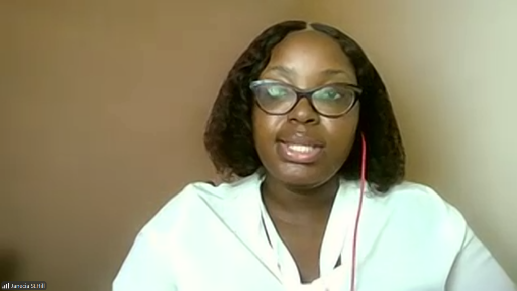 Woman with shoulder-length hair and glasses speaks during a video call, wearing a white blouse.