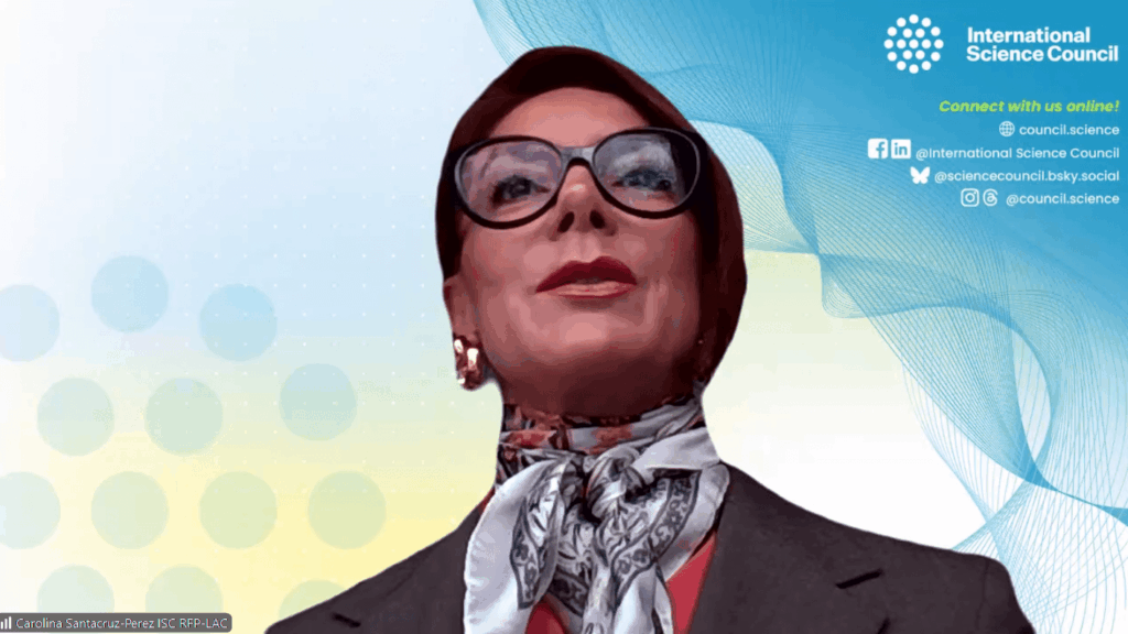 Portrait of a woman in a hijab and glasses delivering a presentation at an International Science Council event, with a blue patterned backdrop.